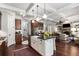 Open-concept kitchen view of the island, breakfast bar, and adjoining living area at 320 Wisteria Cir, Roswell, GA 30076