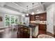 Bright eat-in kitchen featuring an island with seating, stainless steel appliances, and backyard view at 320 Wisteria Cir, Roswell, GA 30076