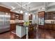 Spacious kitchen with dark wood cabinetry, stainless steel appliances, and a center island at 320 Wisteria Cir, Roswell, GA 30076