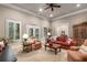Bright living room with neutral carpet, neutral walls, and shuttered windows at 320 Wisteria Cir, Roswell, GA 30076