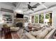Elegant living room boasts a stone fireplace, built-in shelving, and coffered ceilings, with large windows at 320 Wisteria Cir, Roswell, GA 30076