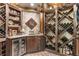 Wine cellar features stone accents, wine racks, and beverage refrigerator at 320 Wisteria Cir, Roswell, GA 30076