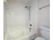 Bathroom featuring tiled walls, a showerhead, and a white tub and toilet at 3301 Henderson Mill Rd # D3, Atlanta, GA 30341