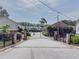 Gated entrance to residential community featuring mature trees and manicured landscaping at 3301 Henderson Mill Rd # D3, Atlanta, GA 30341