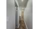 Hallway leading to bathroom features sleek new floors and neutral walls at 3301 Henderson Mill Rd # D3, Atlanta, GA 30341