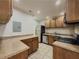 Well-lit kitchen with stainless steel appliances and oak cabinets at 3301 Henderson Mill Rd # D3, Atlanta, GA 30341