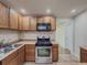 Well-lit kitchen features wooden cabinets, stainless steel appliances, and tile flooring at 3301 Henderson Mill Rd # D3, Atlanta, GA 30341