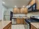 Well-lit kitchen with stainless steel appliances and oak cabinets at 3301 Henderson Mill Rd # D3, Atlanta, GA 30341