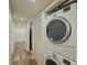 Stacked washer and dryer in hallway laundry area with closet and laminate flooring at 3301 Henderson Mill Rd # D3, Atlanta, GA 30341