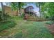 A stone path leads to a swing in the backyard with terraced landscaping and a screened in porch at 4066 Brymond Ct, Tucker, GA 30084