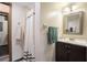 Cozy bathroom with shower, dark wood vanity, sink, mirror, and soft lighting at 4066 Brymond Ct, Tucker, GA 30084