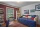 Charming bedroom with built-in bookshelves, wood floors, and a cozy daybed at 4066 Brymond Ct, Tucker, GA 30084
