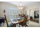 Formal dining room showcasing elegant wallpaper, chandelier, and classic dining set at 4066 Brymond Ct, Tucker, GA 30084