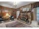 This cozy living room features a stone fireplace, wood paneled walls, and built-in shelving at 4066 Brymond Ct, Tucker, GA 30084