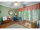 Bright sun room with hardwood floors, green walls, and comfortable wicker chairs at 4066 Brymond Ct, Tucker, GA 30084