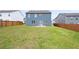Large grassy backyard featuring a newly built home with a fenced perimeter and patio at 108 Berwick Crossing, Dallas, GA 30157
