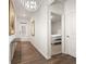 Bright foyer with a chandelier, hardwood floors, and a view into a bedroom, creating an inviting entrance at 108 Berwick Crossing, Dallas, GA 30157