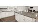Bright kitchen with a granite island, stainless steel appliances, white cabinets, and seating at 108 Berwick Crossing, Dallas, GA 30157