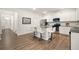 Bright kitchen featuring white cabinets, stainless steel appliances, an island with seating, and hardwood floors at 108 Berwick Crossing, Dallas, GA 30157