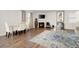 Open living room with fireplace, hardwood floors, modern decor, and a view of the dining area at 108 Berwick Crossing, Dallas, GA 30157