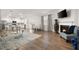 Open concept living room with a fireplace, hardwood floors, and ample natural light from large windows at 108 Berwick Crossing, Dallas, GA 30157