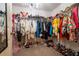 Spacious walk-in closet featuring custom organization, a chandelier, and ample storage for clothes and shoes at 108 Berwick Crossing, Dallas, GA 30157
