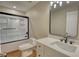 Bathroom featuring a white vanity, black fixtures, and a shower with glass doors at 25 Oakbrook Ln, Covington, GA 30016