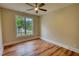 Bedroom with vinyl flooring and window with view of yard at 25 Oakbrook Ln, Covington, GA 30016