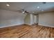 Large bonus room featuring hardwood floors, neutral walls, large windows, and a ceiling fan at 25 Oakbrook Ln, Covington, GA 30016