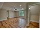 Large bonus room featuring hardwood floors, neutral walls, a window, and a ceiling fan at 25 Oakbrook Ln, Covington, GA 30016