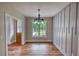 Inviting dining room features a decorative accent wall, wood-look floors, and natural light from the window at 25 Oakbrook Ln, Covington, GA 30016