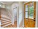 Inviting entryway with a wooden door, staircase, and wood-look floors at 25 Oakbrook Ln, Covington, GA 30016