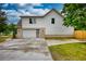 View of the home's exterior featuring a driveway leading to the garage and a well-maintained lawn at 25 Oakbrook Ln, Covington, GA 30016