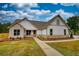 Charming two-story home with brick and siding, complemented by a well-manicured lawn and inviting walkway at 25 Oakbrook Ln, Covington, GA 30016