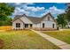 Beautiful home exterior with a brick and siding facade, complemented by lush landscaping and a walkway at 25 Oakbrook Ln, Covington, GA 30016