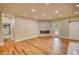 Spacious living room featuring fireplace, wood flooring, and barn doors at 25 Oakbrook Ln, Covington, GA 30016