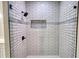 Modern tiled shower with glass door and black hardware at 25 Oakbrook Ln, Covington, GA 30016