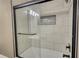Modern shower features tile and glass shower door at 25 Oakbrook Ln, Covington, GA 30016