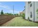 Spacious backyard with a lush lawn, privacy fence, and patio area at 3399 In Bloom Way, Auburn, GA 30011