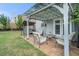 Outdoor patio with covered seating and a well-maintained lawn at 3399 In Bloom Way, Auburn, GA 30011