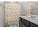A clean bathroom featuring a sleek sink and a stylish shower curtain at 3399 In Bloom Way, Auburn, GA 30011