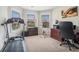 Bright bedroom featuring modern carpet, window blinds, and workout equipment including a treadmill at 3399 In Bloom Way, Auburn, GA 30011