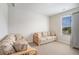 Bright and airy bedroom with comfortable seating and a window for natural light; creates a relaxing atmosphere at 3399 In Bloom Way, Auburn, GA 30011