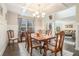 Elegant dining room with coffered ceiling, detailed trim, and a view into the living room at 3399 In Bloom Way, Auburn, GA 30011