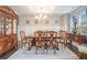 Formal dining room with wainscoting, hardwood floors, elegant chandelier and a large dining table at 3399 In Bloom Way, Auburn, GA 30011