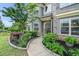Walkway to front door with lush landscaping; gray brick and siding exterior under a blue sky at 3399 In Bloom Way, Auburn, GA 30011