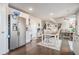 Bright kitchen boasts stainless steel appliances, white cabinetry, and an adjacent dining area perfect for Gathering meals at 3399 In Bloom Way, Auburn, GA 30011