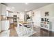 Charming kitchen with a dining table, stainless steel appliances, and white cabinets offers a cozy and functional space at 3399 In Bloom Way, Auburn, GA 30011