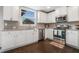 Bright kitchen featuring white cabinets, stainless steel appliances and mosaic tile backsplash at 3399 In Bloom Way, Auburn, GA 30011