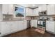 Well-lit kitchen featuring stainless steel appliances, granite countertops, and dark wood floors is both stylish and practical at 3399 In Bloom Way, Auburn, GA 30011